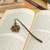 Zamac metal bookmark, 'Lucky Royal Petals' - Zamac Metal Bookmark with Antique-Finished Golden Clover