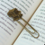 Zamac metal bookmark, 'Regal Adventures & Pages' - Book-Themed Antiqued Golden Zamac Metal Clip Bookmark