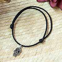 Men's sterling silver charm cord bracelet, 'Hypnotic Skull' - Adjustable Men's Cord Bracelet with Taxco Silver Skull Charm