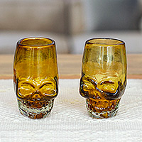 Handblown recycled glass tequila glasses, 'Amber Mexican Skull' (pair) - Pair of Handblown Recycled Glass Brown Skull Tequila Glasses