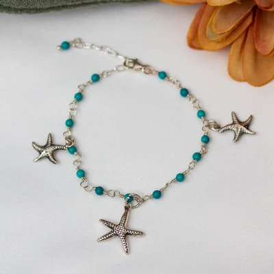 Sterling silver charm bracelet, 'Refreshing Stardom' - Sea-Inspired Reconstituted Turquoise Starfish Charm Bracelet