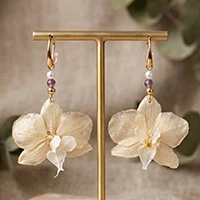 Gold-accented natural flower and amethyst statement earrings, 'Luminous Orchid' - Gold-Accented Natural White Orchid Amethyst Dangle Earrings