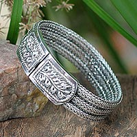 Sterling silver wristband bracelet, 'Braided Hideaway' - Handcrafted Floral Sterling Silver Bracelet