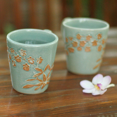 Celadon ceramic coffee mugs, 'Golden Orchid' (pair) - Unique Floral Ceramic Coffee Mugs (Pair)