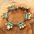 Brass charm bracelet, 'Fortune's Blue Melody' - Elephant and Bell Charm Bracelet in Blue Gems and Brass thumbail