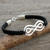 Sterling silver pendant bracelet, 'Double Infinity' - Black Leather Macrame Bracelet with Silver Infinity Pendant (image 2) thumbail