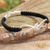Leather and sterling silver braided bracelet, 'Infinitely Us' - Thai Sterling Silver and Black Leather Braided Bracelet thumbail