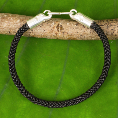 Braided leather bracelet, 'Elephant Promise in Black' - Braided Leather Cord Bracelet with Silver Elephant Clasp