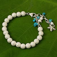 Sterling silver and cultured pearl beaded charm bracelet, 'Sparkling Waves' - Artisan Crafted Silver Bracelet with Starfish Charm