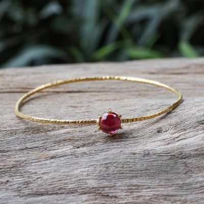 Gold plated garnet bangle bracelet, 'Meteor' - Gold Plated Garnet Bangle Bracelet from Thailand