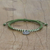 Silver charm bracelet, 'Ancient Om in Green' - Silver Om Charm Bracelet on Braided Green Cords