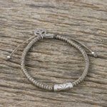 Silver accented cord bracelet, 'New Dawn' - Grey Cord Flower Motif Bracelet with Silver Peace Charm