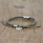 Silver accented cord bracelet, 'New Dawn' - Grey Cord Flower Motif Bracelet with Silver Peace Charm