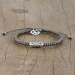 Silver accented cord bracelet, 'New Dawn' - Grey Cord Flower Motif Bracelet with Silver Peace Charm