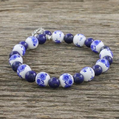 Lapis lazuli and ceramic beaded charm bracelet, 'Ming Lotus' - Blue and White Beaded Stretch Bracelet from Thailand