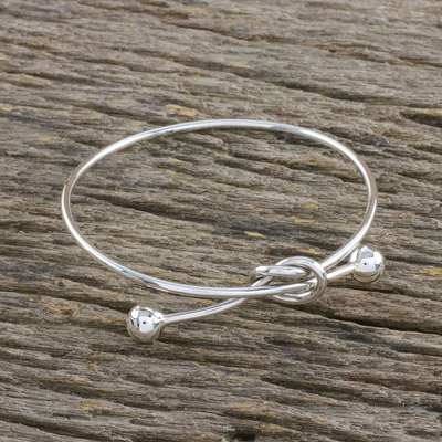 Sterling silver bangle pendant bracelet, 'Tie the Knot' - Sterling Silver Wire Bangle Bracelet with Knot Pendant