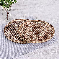Bamboo and rattan trays, 'Presenting Pikul' (8 and 9 inch, pair) - Handcrafted Woven Flower Motif Rattan Trays (Pair)