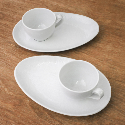 Ceramic cups and snack plates, 'Snow White' (set for two) - Artisan Crafted White Ceramic Set of Two Cup and Snack Plate