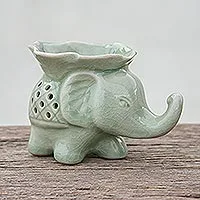 Celadon ceramic oil warmer, 'Elephant and Leaf' - Celadon Ceramic Elephant Oil Warmer from Thailand