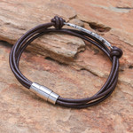 Stainless steel and leather pendant bracelet, 'Stunning Feather in Brown' - Stainless Steel and Brown Leather Feather Pendant Bracelet