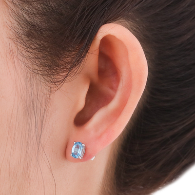 Blue topaz stud earrings, 'London Ovals' - Faceted Blue Topaz Stud Earrings from Thailand