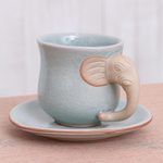 Celadon ceramic cup and saucer, 'Elephant Gaze' - Aqua Celadon Cup and Saucer with Elephant Motif