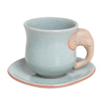 Celadon ceramic cup and saucer, 'Elephant Gaze' - Aqua Celadon Cup and Saucer with Elephant Motif
