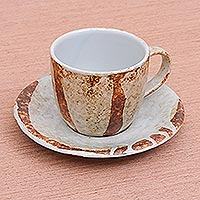 Ceramic cup and saucer, 'Natural Appeal' - White and Brown Handmade Ceramic Cup and Saucer Set