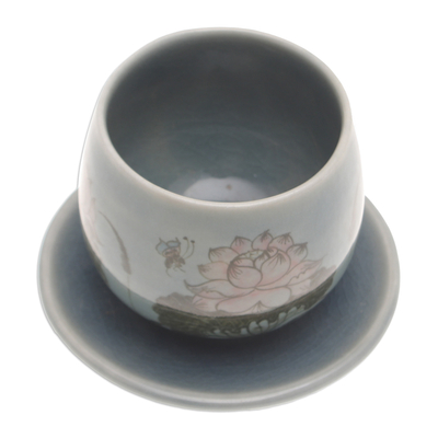 Celadon ceramic cup and saucer, 'Luxuriant Lotus in Blue' - Handmade Celadon Ceramic Blue Cup and Saucer with Flowers