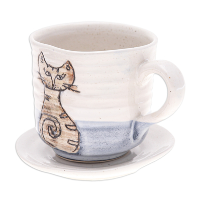 Ceramic cup and saucer, 'Whimsical Cat' - Handcrafted Ceramic Cup and Saucer Set with Cat Motif