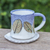 Ceramic mug and saucer, 'Charming Leaves' - Handcrafted Ceramic Mug and Saucer Set with Leaf Motif