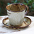 Ceramic cup and saucer, 'Leafy Warmth' - Handcrafted Leafy Brown Ceramic Cup and Saucer from Thailand