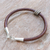 Leather pendant bracelet, 'Earth Rings' - Sterling Silver Pendant Bracelet with Brown Leather Cord