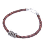 Leather braided pendant bracelet, 'Ties of the Earth' - Brown Leather Braided Bracelet with Sterling Silver Pendants
