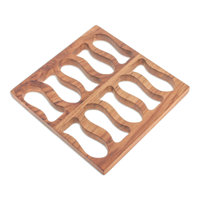 Wood pot stand, 'Swimming Delicacies' - Fish-Themed Hand-Carved Square Brown Teak Wood Pot Stand