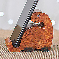 Wood phone holder, 'Dino Assistant' - Hand-Carved Brown and Black Dino Raintree Wood Phone Holder
