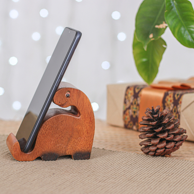 Wood phone holder, 'Dino Assistant' - Hand-Carved Brown and Black Dino Raintree Wood Phone Holder