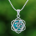 Sterling silver pendant necklace, 'Sacred Peace Bloom' - Floral Om-Themed Reconstituted Turquoise Pendant Necklace