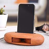 Cherry wood phone speaker, 'Serene Sounds' - Hand-Carved Minimalist Oval Cherry Wood Phone Speaker