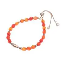 Carnelian beaded bracelet, 'Fiery Fish' - Natural Carnelian Beaded Bracelet with Brass Fish Pendant