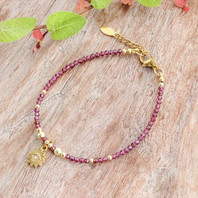 Gold-accented garnet beaded charm bracelet, 'Garnet Guardian' - 18k Gold-Accented Natural Garnet Bracelet with Golden Charm