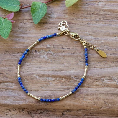 Gold-accented lapis lazuli beaded charm bracelet, 'My True Memory' - 18k Gold-Accented Lapis Lazuli Bracelet with Elephant Charm