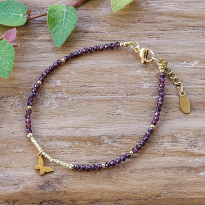 Gold-accented garnet beaded charm bracelet, 'Flutter My Love' - Butterfly-Themed Natural Garnet Bracelet with Gold Accents